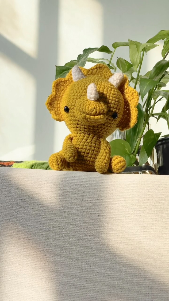 Crochet yellow triceratops dinosaur toy
